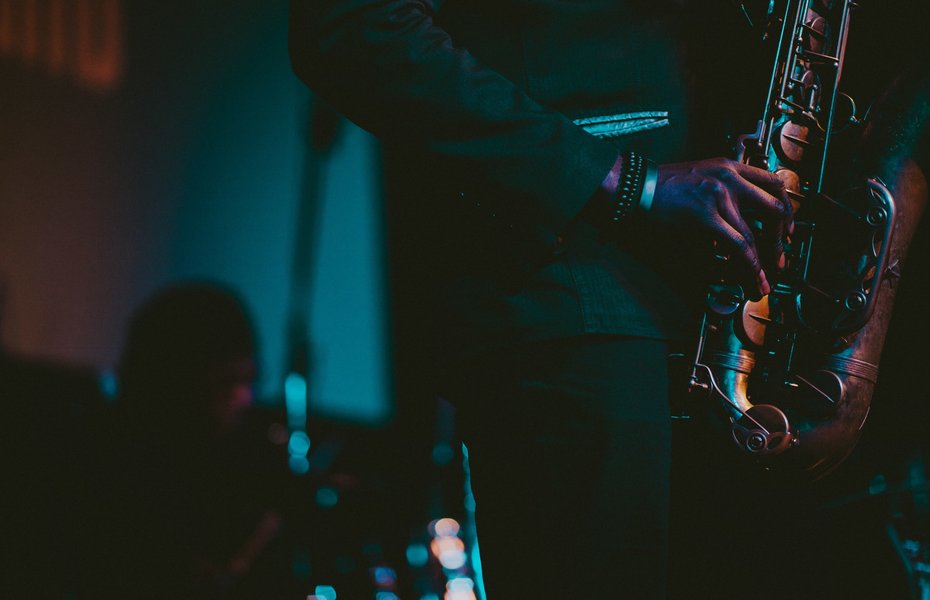 man_in_a_suit_playing_saxophone_into_a_mic_2024_09_21_22_21_41_utc_min